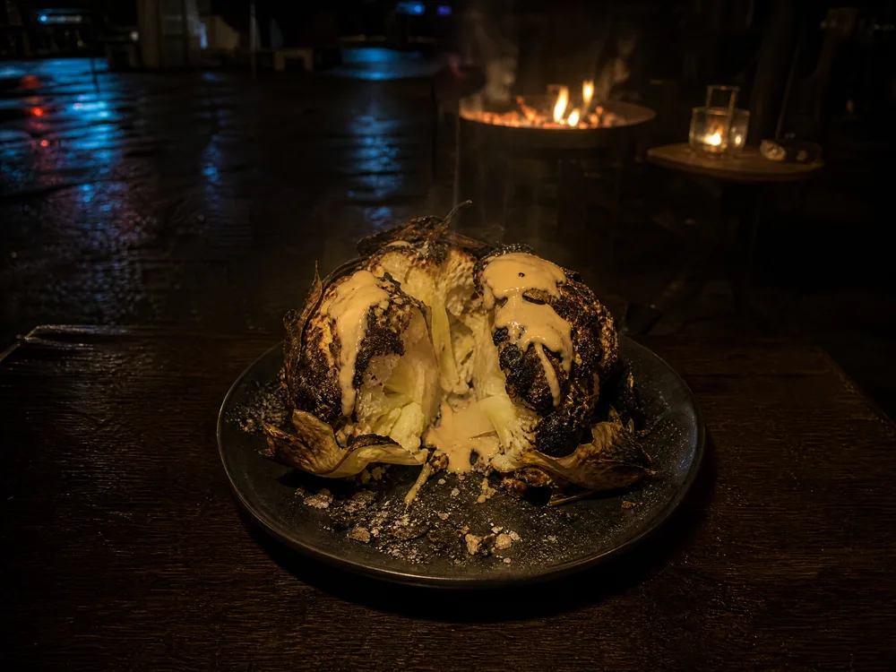 Chou-fleur entier rôti dans la cendre, ouvert, avec du tahini